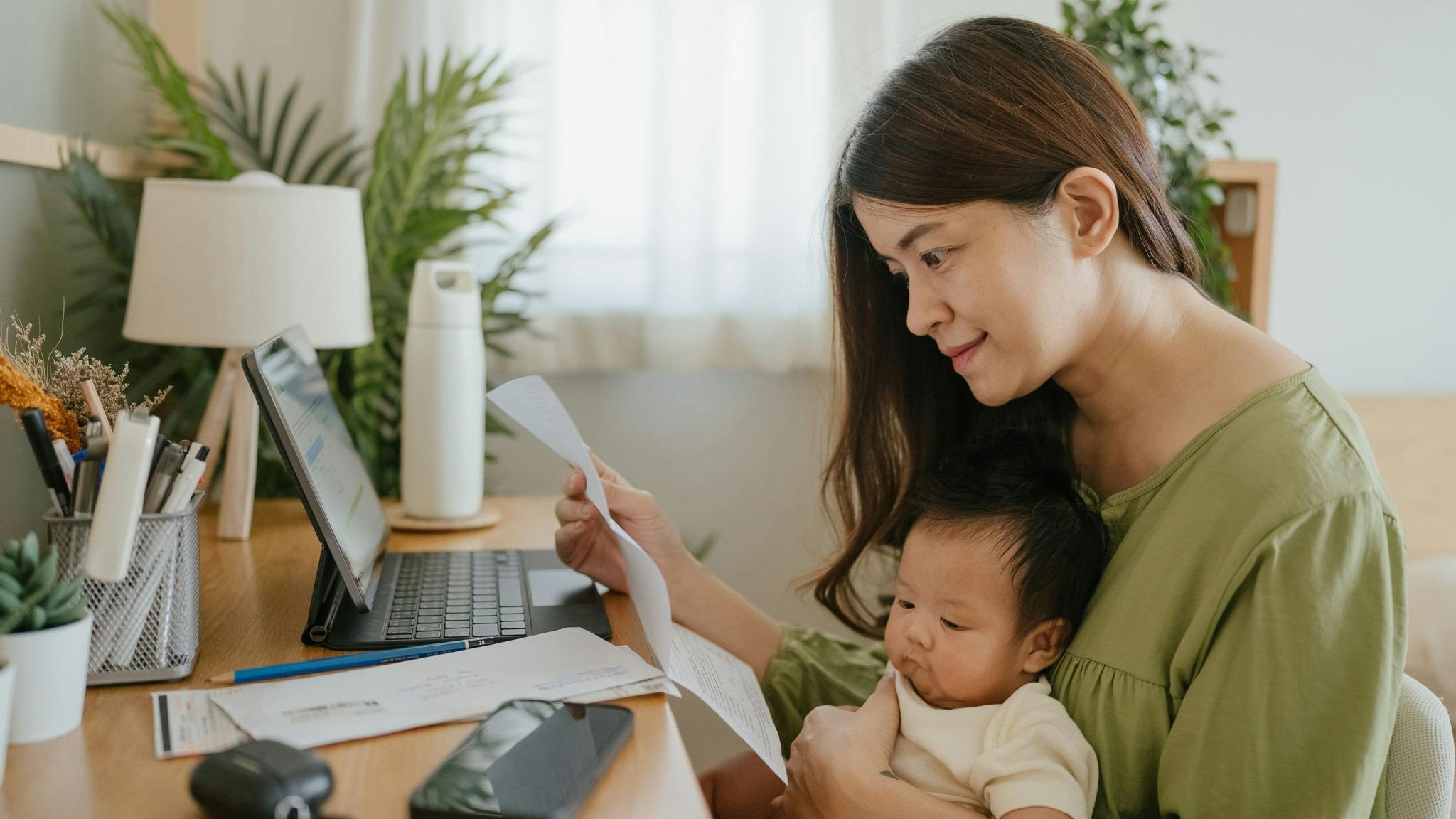 Mother with child doing their finances.